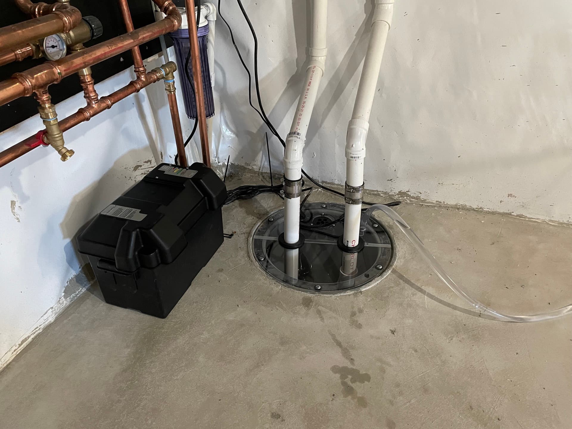 Sump pump and basin installed in a Central Maine basement by Nason's Home Solutions