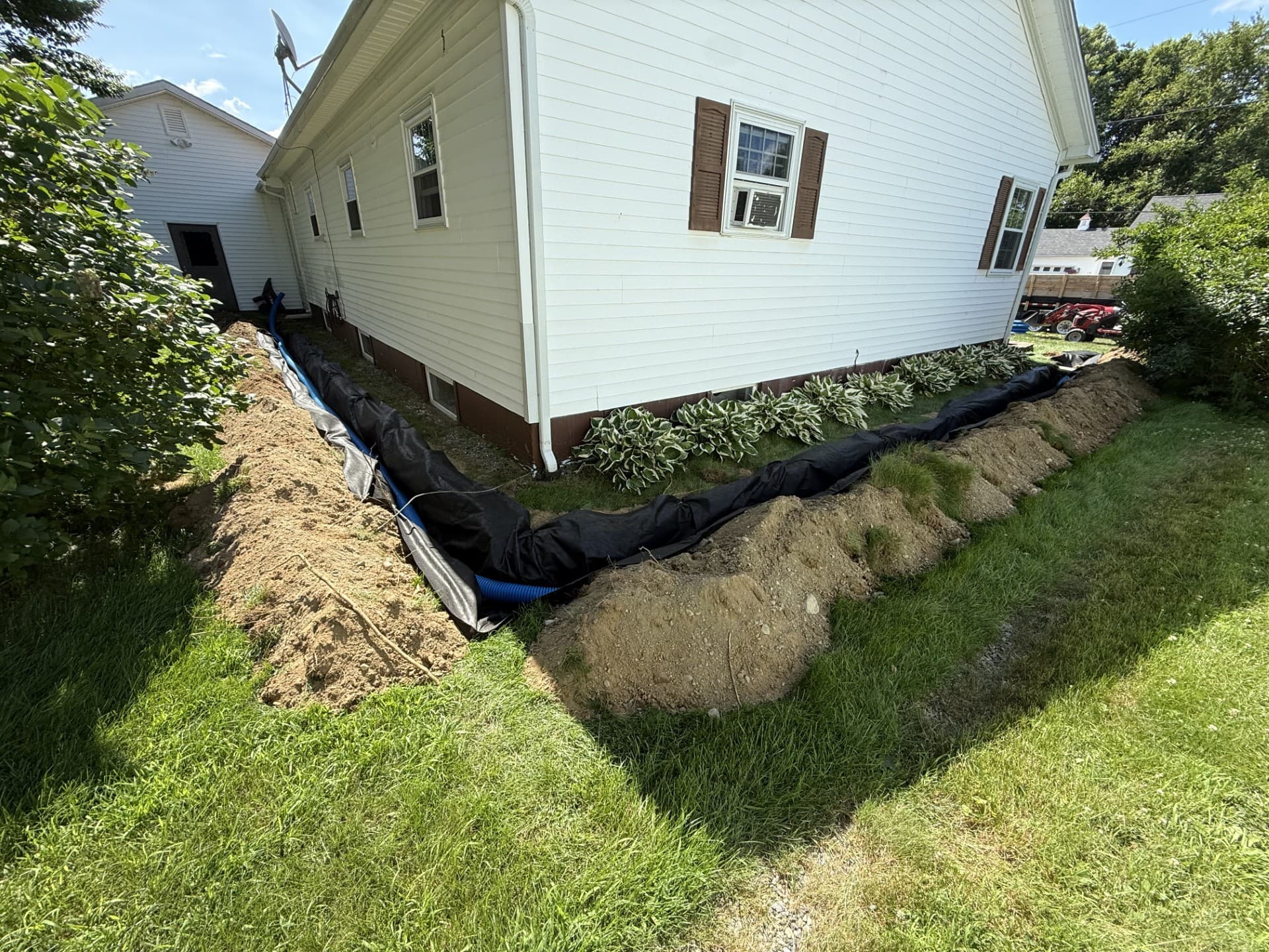 Interior drainage channel being installed along a basement wall by Nason's Home Solutions